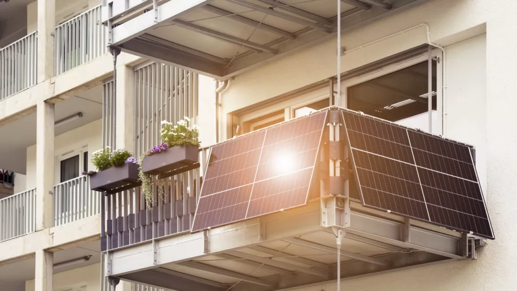 Solar Panel on Balcony Flat or Apartment Building. Solar Modern Balcony with Sun Light Reflection in Green City. Solar Technology Equipment. Green Energy Concept.